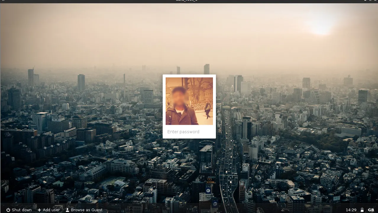 Computer login screen over a city view