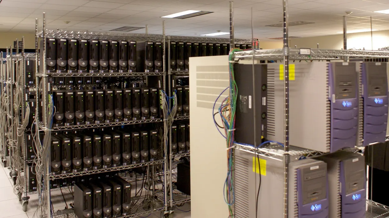 Shelves of computer servers with cables in a server room