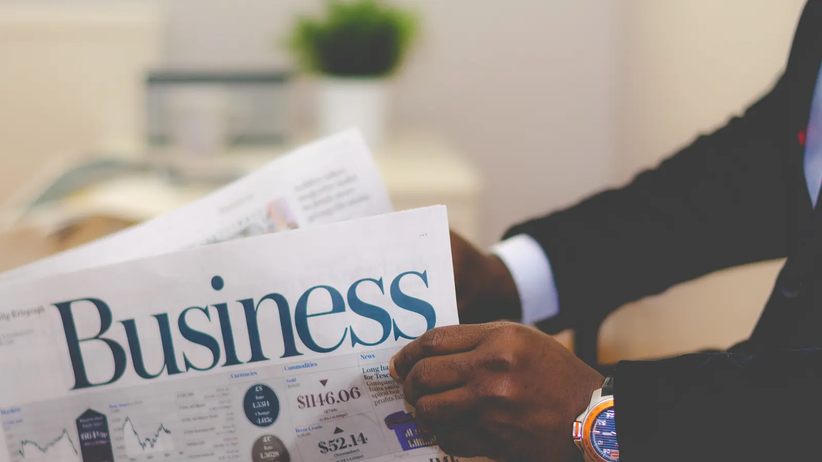 Person reading a business newspaper