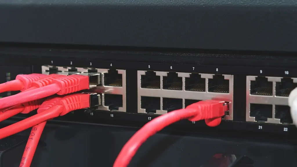 Red network cables connected to a network switch