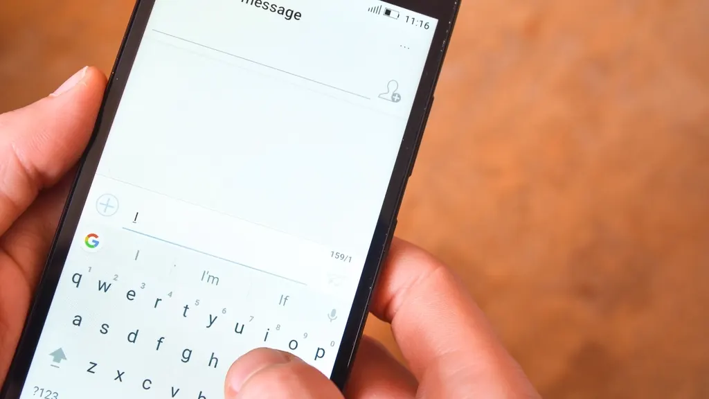Hands typing a message on a smartphone