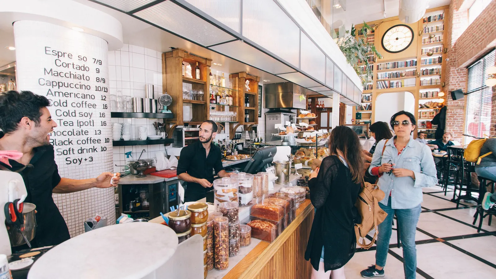 Customers ordering at a café counter