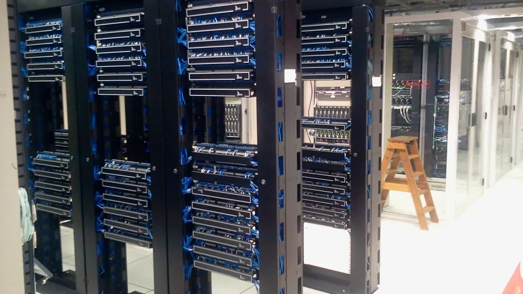 Rows of server racks in a bright data centre